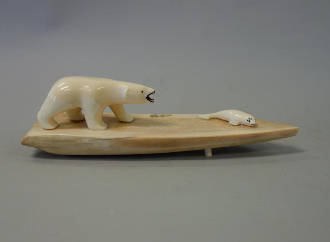 Alaskan Inuit Carving by Luke Kulukhon: An Alaskan Inuit carving by Luke Kulukhon, Nome, Alaska, B.O.T. Carved from walrus tusk to depict a polar bear in pursuit of a seal. Measures 8.5" long, 2-3/8" high, 2-3/8" wide. Signed on the undersi