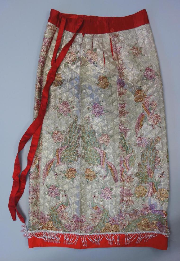Chinese Metallic Couched & Embroidered Skirt: A Chinese embroidered red silk skirt, featuring overall metallic couched peacocks and birds flying among abundant flowers and foliage. Beaded fringe at the bottom. Measures 37" long. The waist measure