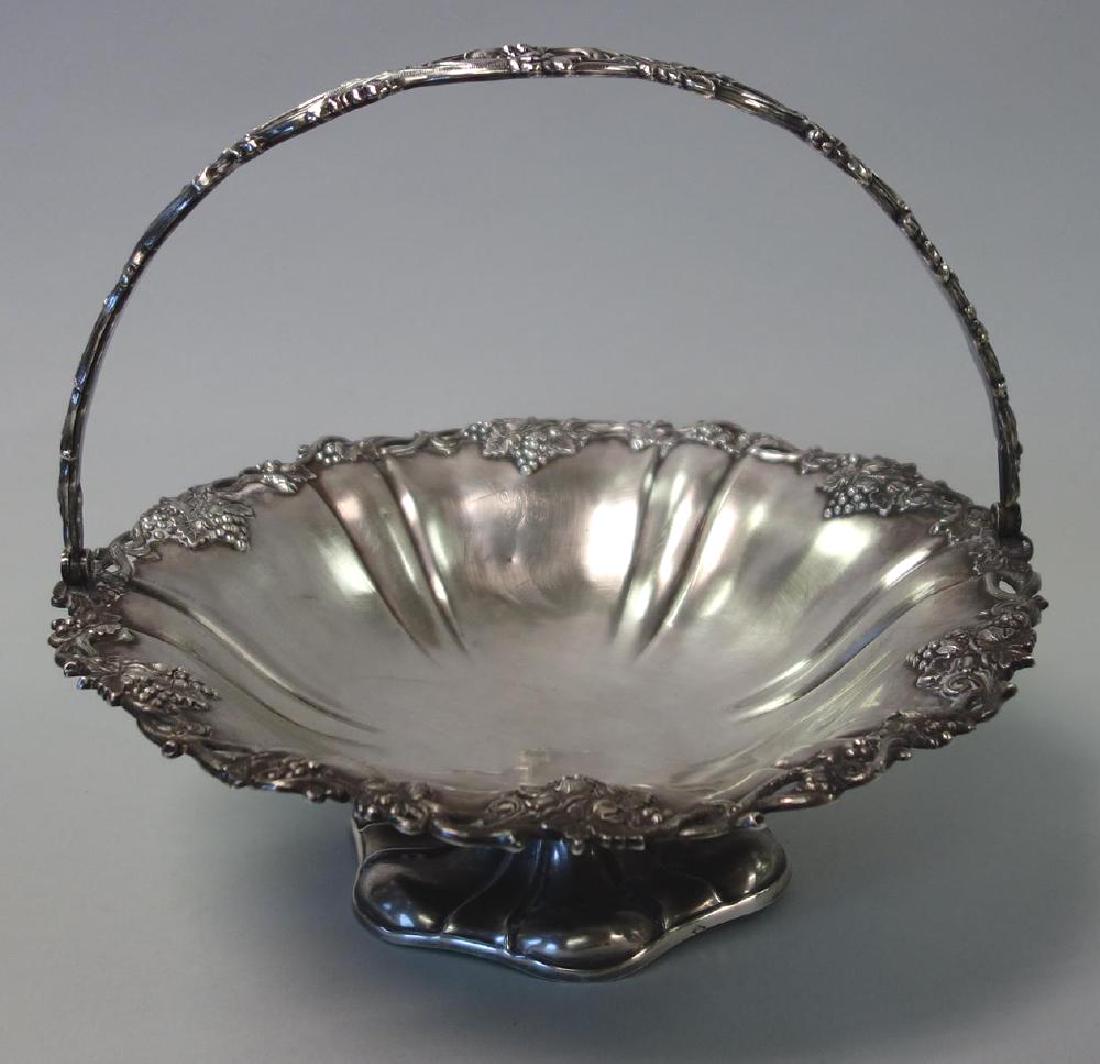 Alphonese Debain French Silver Handled Basket: A French handled and footed silver basket. Hallmarked for Alphonse Debain, France, and with the Mercury mark indicating 950 silver purity. The border with repousse and chased decoration depicting grap