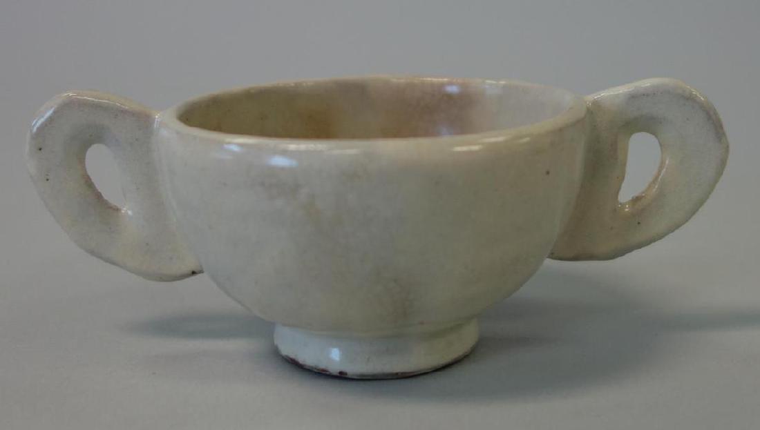 Korean Porcelain Handled Wine Cup, Yi Dynasty: A Korean porcelain double handled wine cup, Choson / Yi Dynasty, late 19th / early 20th century. Light white to celadon glazed cup with interior crackle glaze. Measures 4.75" from end of handles, 2.75