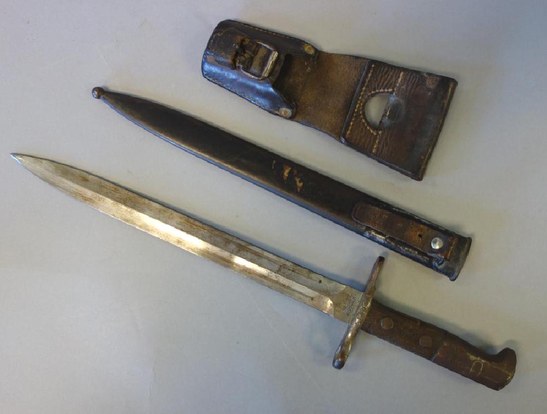 Waffenfabrik Neuhausen Swiss Bayonet +: A Waffenfabrik Neuhausen Swiss bayonet. Numbered 520734. Overall measures 16-7/8" long to end of wood handle. With scabbard and leather holster. The holster stamped Cesar Heller, Wolhusen (Wolhusen is