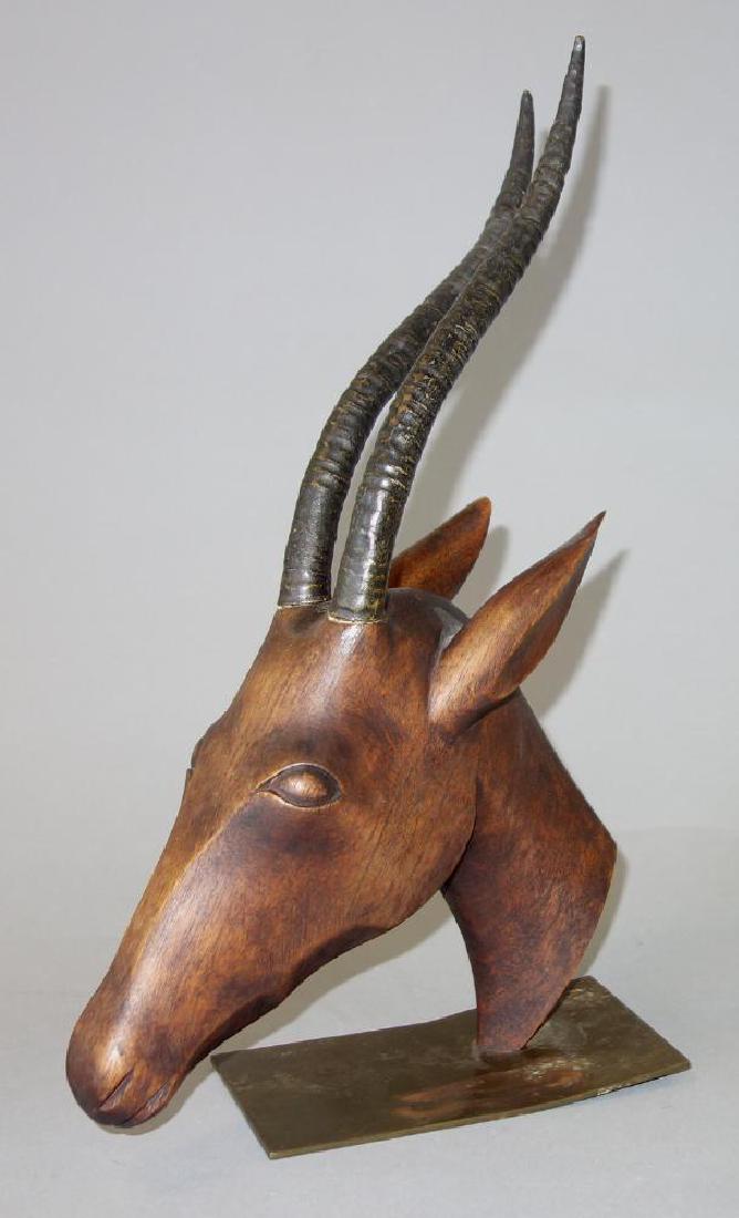 Franz Hagenauer Sculpture of an Ibex: A Franz Hagenauer sculpture of an ibex. Carved wood with patinated bronze metal horns, mounted on a brass base. Measures 13.75" high, 9" wide, 5" wide. Marks on base: Hagenauer Wein, Handmade, Made in