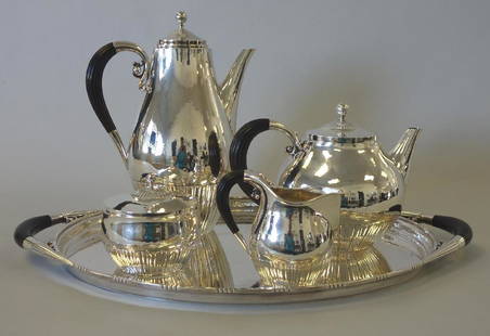 Georg Jensen Sterling Cosmos Coffee Tea Service: A fine and impressive Danish sterling silver coffee / tea service by Georg Jensen in the Cosmos pattern designed in 1915 by Johan Rohde (1856-1935), Denmark. The hand-hammered set is comprised of a