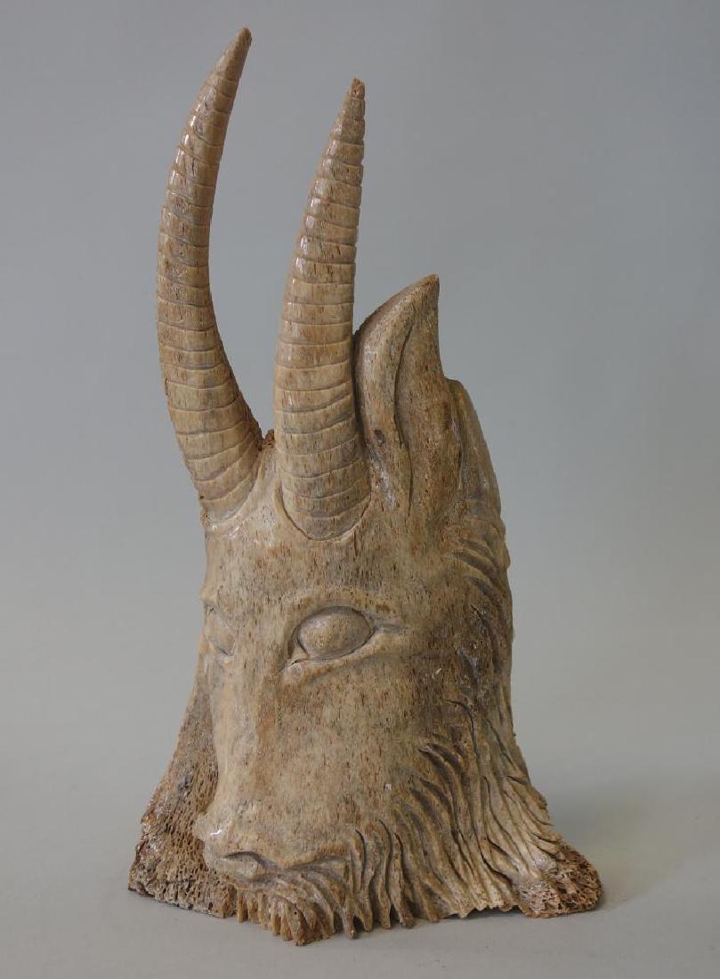 Fossilized Bone Sculpture of a Mountain Goat: A carved fossilized bone sculpture of a mountain goat...possibly Inuit / Alaskan. Measures 11" high, 6.25" wide, 2.5" deep.