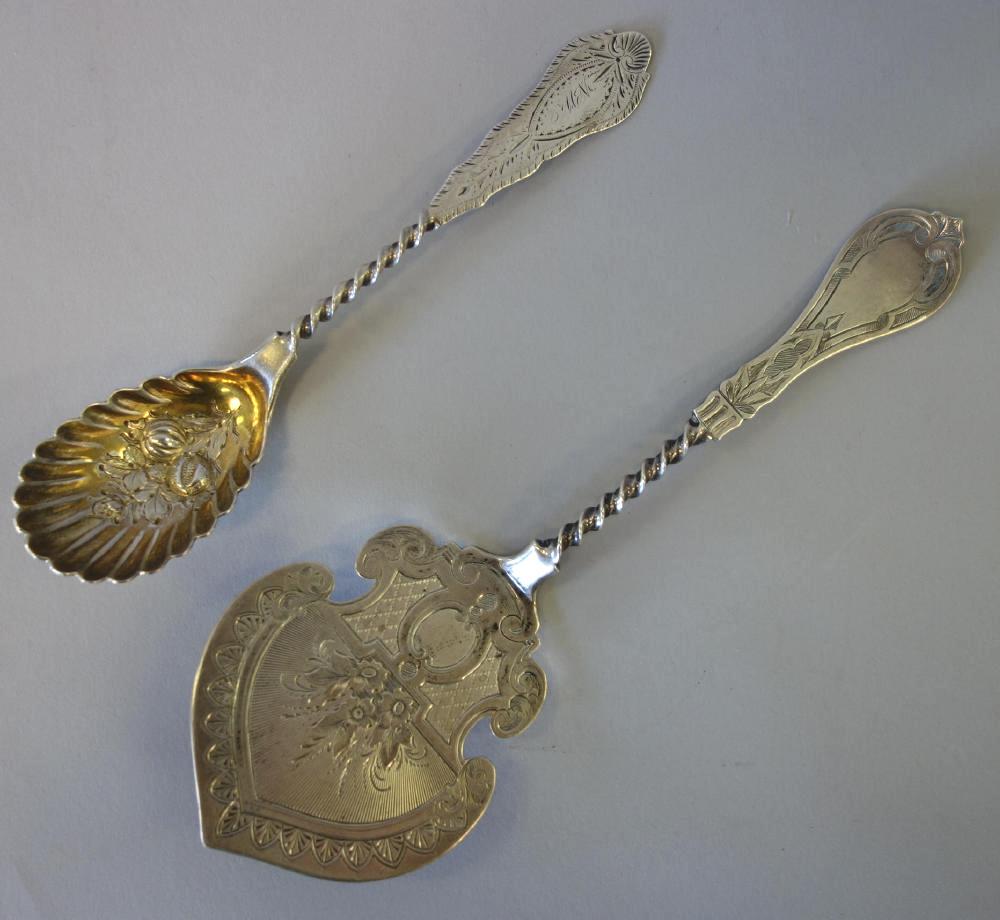 Albert Coles Coin Silver Serving Pieces, New York: Two American coin silver serving articles by Albert Coles, New York, c.1835-1875. Comprised of a sugar spoon with gold wash bowl, bright-cut and spiral-twist handle. The oval scalloped bowl embossed w