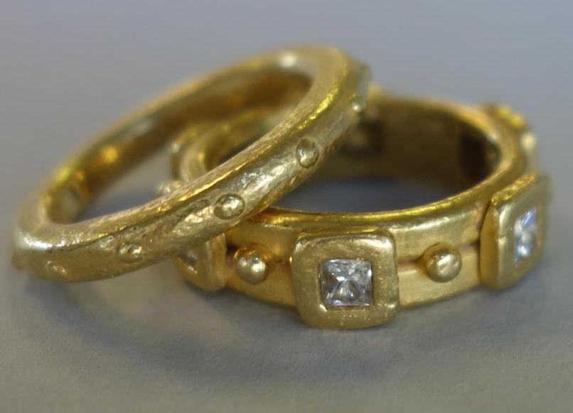 Denise Roberge 22K Gold & Diamond Rings: Two Denise Roberge ring bands. Comprised of a 22K yellow gold ring set with six square cut diamonds (ring size 4.25). Together with a 22K yellow gold band with a raised ball design (ring size 5). Each