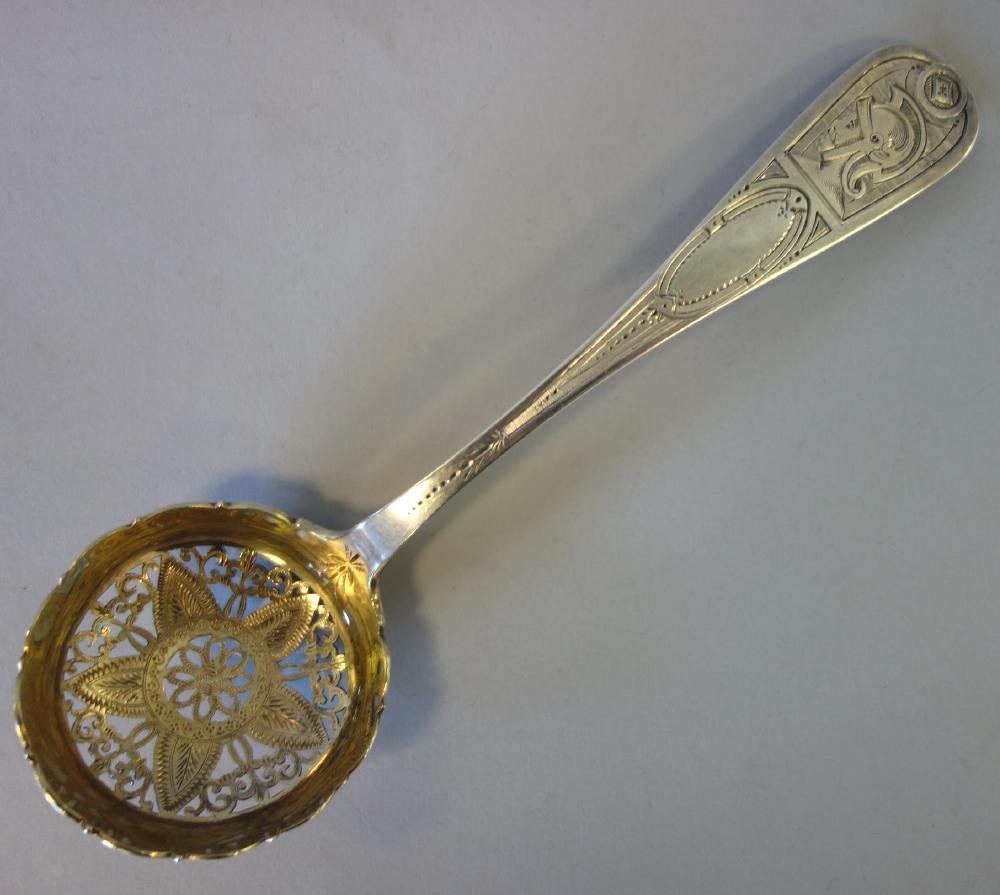 William Gale & Son Sterling Sifting Spoon: A fine American sterling silver sifting spoon / tea strainer by William Gale & Son, New York. Gold wash open-work bowl having a floral / leaf motif. The handle tip etched with the profile of a Roman C
