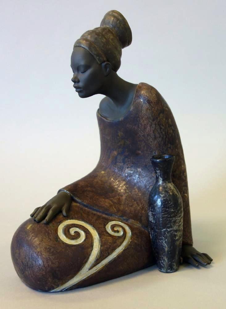 Lladro Porcelain African Woman Sculpture, #2473: A Lladro porcelain figural sculpture of a young African woman in contemplation. Handmade in Spain, sculpted by Jose Santaeulalia, # 2473. Measures 10" high, 7.5" wide, 7" deep. CONDITION: no adverse c