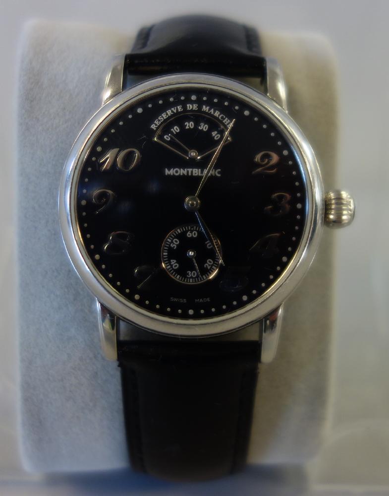 Mont Blanc Meisterstruck Reserve De Marche Watch: A Montblanc Meisterstuck Swiss Made wristwatch. Reserve De Marche. Black dial with chronograph. Model 7017, PL40601, Stainless Steel, Water Resistant 30M. With original wristband. Currently in well ru