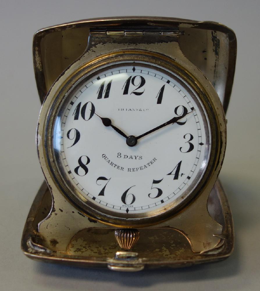 Tiffany 8-Day Quarter Repeater, Herald Co, Swiss: A cased 8-Day Quarter Repeater by Herald Watch Company. Retailed by Tiffany & Co. The nickel silver travel case holds the hinged clock. The movement marked Herald. W. Co. Swiss. The cased stamped Nick