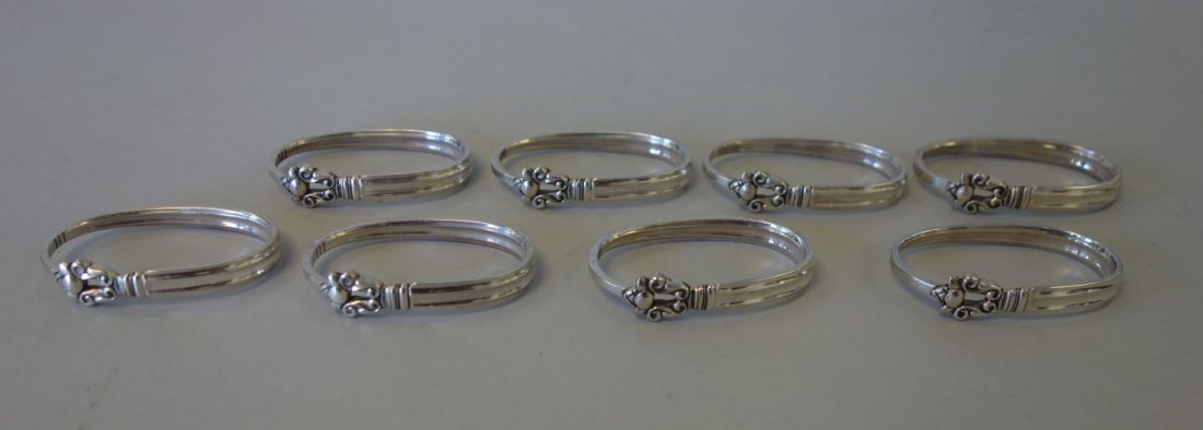 Georg Jensen Sterling Acorn Napkin Rings, Set of 8: A set of eight Danish sterling silver napkin rings by Georg Jensen, Denmark in the Acorn pattern. Stamped with the Jensen maker's mark used 1945 - present, Sterling, Denmark. No monograms. Overall wei