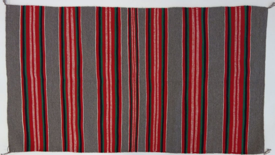 Mary Lee, Wide Ruins Navajo Rug Weaving: A Navajo Wide Ruins rug weaving by Mary Lee. Wool rug with bright colors of red, green and white on a gray field. Includes documentation identifying the weaver. Measures 61.5" x 34.5".PROVENANCE: Burn
