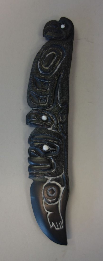 Haida Argillite Totem Motif Letter Opener / Knife: A Haida argillite carving, formed as a letter opener knife with a totem motif. The backside engraved: "Eagle Sitting on Man with Eagle Headdress". Artist signed K. Jeger Ohai, Old Massett Haida Gwaii,
