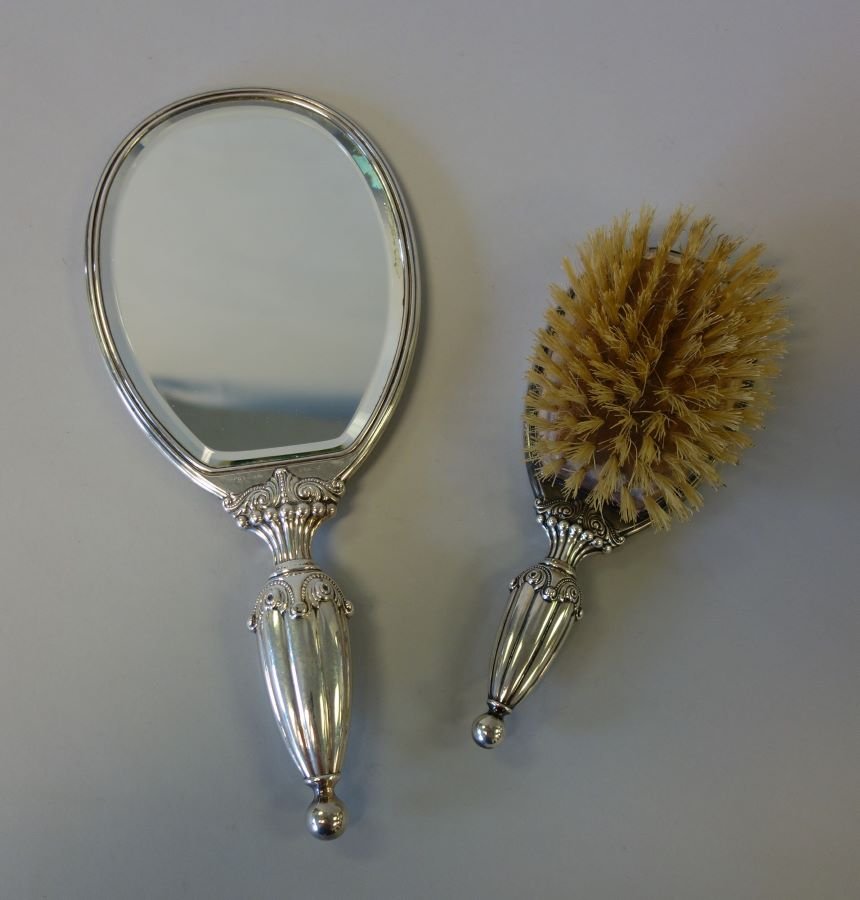 R. Wallace & Sons Sterling 2-Piece Vanity Set: An American sterling silver 2-piece vanity / dresser set by R. Wallace & Sons. Pattern 245-2. The handles having a ribbed classical design with a scrolling motif. The hand mirror measures 11-1/8" high