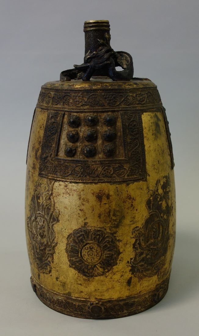 19thc Korean Bronze Bell, Dragon Motif: A Korean gilt bronze bell. 19th century. Cylindrical shape surmounted by a five-clawed dragon / mythological beast at the handle. Cast with raised Buddhist figures and scrolling vine and berry borders