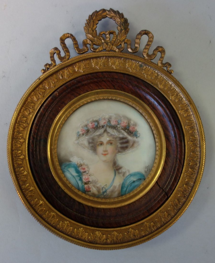 19thc French Portrait Miniature, Signed: A 19thc French miniature portrait of a young woman, c.1860s. The watercolor and gouache portrait painting depicts a lovely young woman wearing a large floral covered hat. Artist signed indistinctly Ge