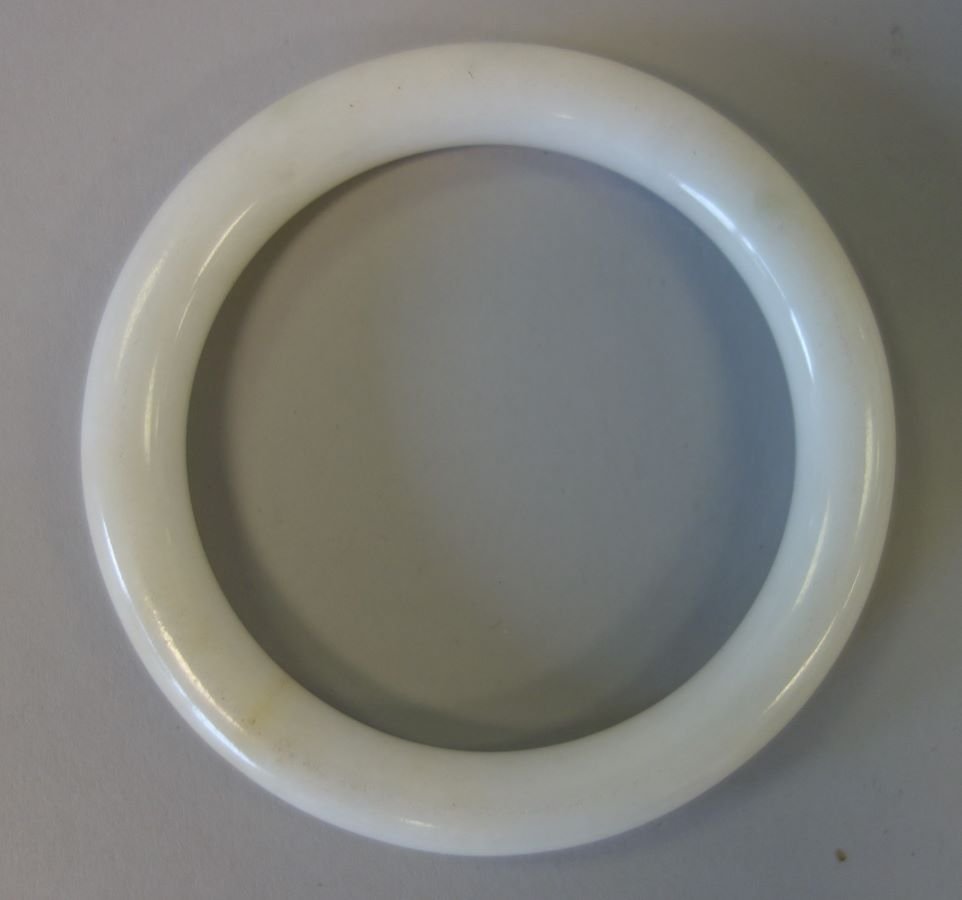 Chinese White Jade Mutton Fat Bangle Bracelet: A Chinese white jade mutton fat bangle bracelet. Exterior circumference 10.25" x 3/8" wide. Interior circumference, 7".CONDITION NOTE: faint partial hairline, see photos.