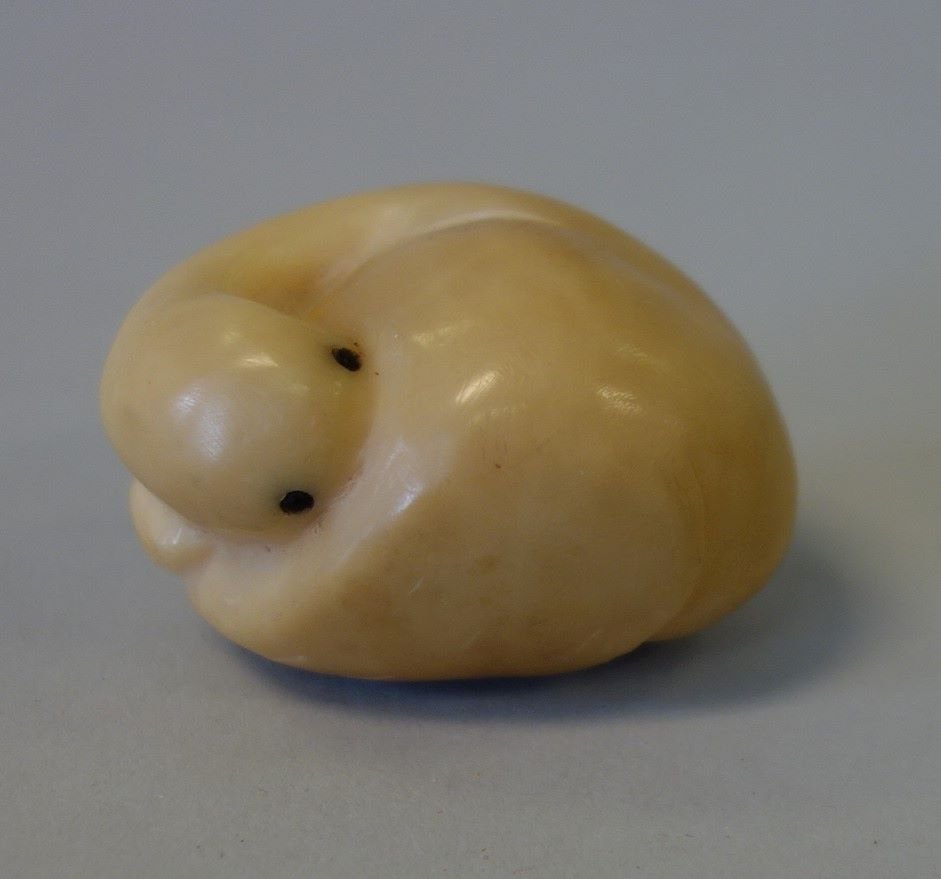 Japanese Tagua Nut Goose Formed Netsuke, Signed: A Japanese Tagua nut netsuke. Carved and formed as a goose. Signed with cipher / chop underfoot. Measures 2" x 1.5" x 1.25" high.