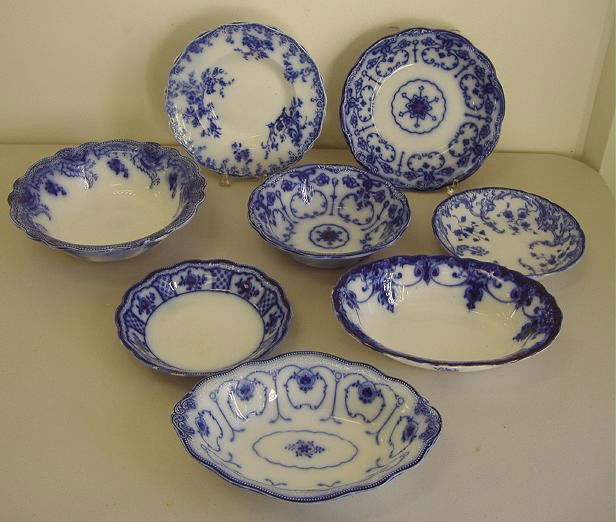 Nine Grindley & Co Flow Blue Serving Bowls: Includes seven serving bowls of various patterns and sizes and two soup bowls.
