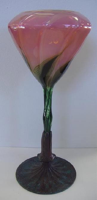 Tiffany-Style Lundberg Studios Floriform Vase: Unsigned art glass floriform vase with bronze base attributed to Lundberg Studios. Measures 13" tall.