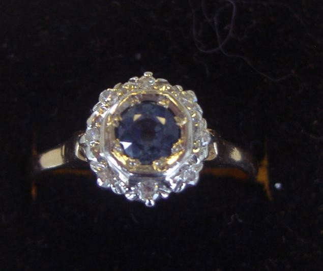 Sapphire & Diamond Ring set in 14K (vintage): Sapphire center stone and eight diamonds set in 14K white and yellow gold. Ring size 7.75.