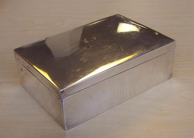 Asprey Sterling Cigarette Box, London, 1901: Hallmarked CA.GA for Charles and George Asprey. The box measures, 6" long, 4" deep and 1-7/8" high. Overall scratching, warped interior. Monogram E.F. 1902.