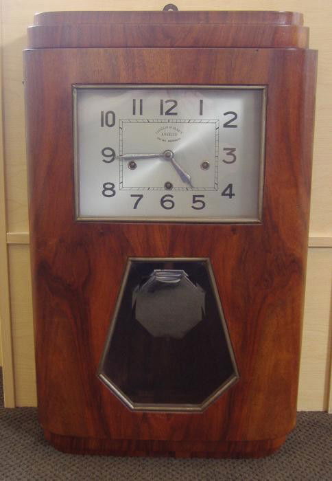 Art Deco Angelus Clock, Carillons de France: Art deco wood case with an Angelus clock. Currently in good working order. Plays five different tunes (Je Sonne 5 Carillons). Has pendulum and key. Measures 27" high, 17" wide and 7" deep.
