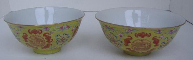 Two Chinese Famille Jaune Bowls w/Bats, signed: Two Chinese famille jaune porcelain bowls, with bats encircling a Chinese symbol. The bowls each measure 4.5" in diameter and 2.25" high. Signed underfoot with a 4-character mark.