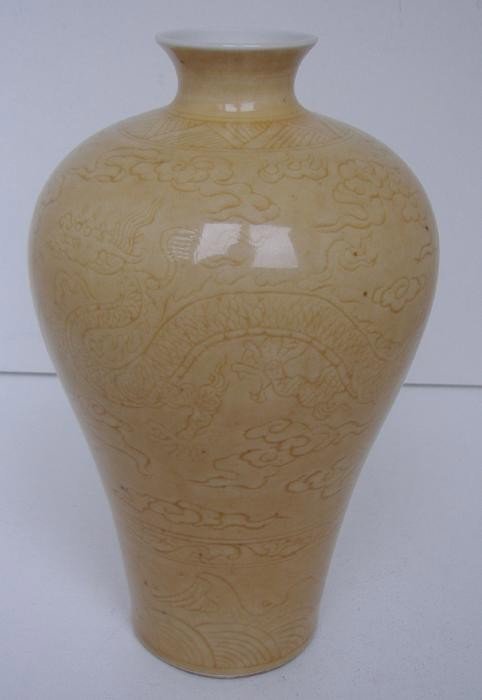 Chinese Porcelain Vase, w/ Chenghua Mark: The vase has incised designs of two dragons among clouds with water and waves at the bottom. The underside bears the Chenghua mark, (1465-1487). The vase measures 6.5" tall.