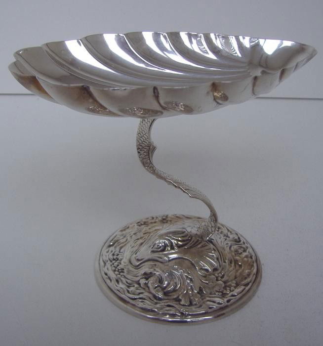 Gorham Sterling Shell/Dolphin Formed Dish: Sterling shell formed dish by Gorham on a dolphin formed base (weighted base). Measures 5.75" long, 3.5" wide and 4.5" tall.