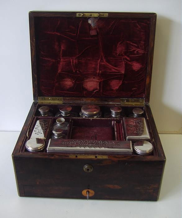 19thc English Traveling Vanity Box Macassar Ebony: 19thc English traveling vanity box of macassar ebony. Complete with glass jars and boxes. Locking lower drawer with key. Top portion has a bramah lock, although missing key. The lid has an inlay brass