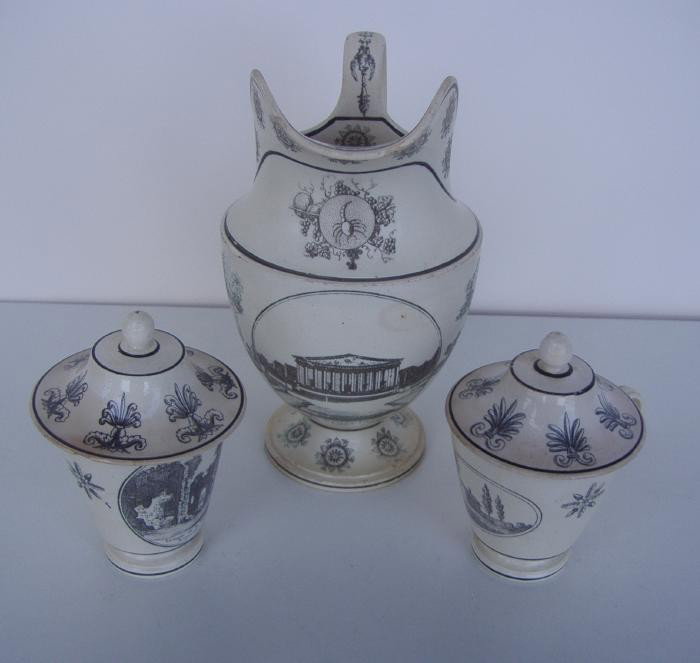 Creil Creamware Pitcher & 2 Pot de Cremes: A Creil creamware pitcher together with two covered Creil pot de cremes, decorated in black transfer-printed. The pitcher measures 6" high. NOTE: some chipping to spout of pitcher and underside foot.
