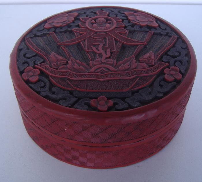 Chinese Carved Cinnabar Lacquer Lidded Box: The box measures 5.75" in diameter and 2.25" high.
