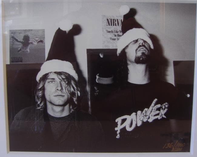 Nirvana Kurt Cobain & Krist Novoselic Photo: Framed photo by Darrell M. Westmoreland of Nirvana's Kurt Cobain and Krist Novoselic. Edition 136/1000. The photo measures 7.5" x 9.25". The framed measurement: 16.5" x 18.5"