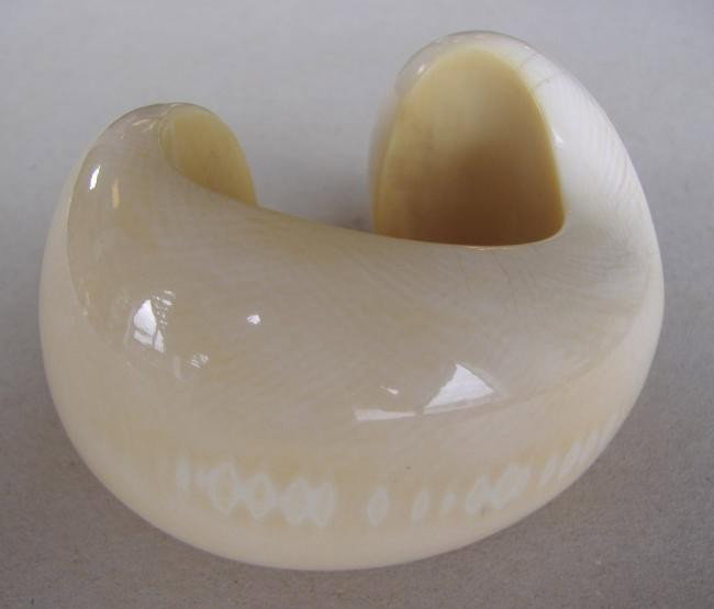 Patricia Von Musulin Ivory Sculptural Bracelet: Ivory cuff bracelet by jewelry designer Patricia Von Musulin. This sculptural piece measures 8-3/8" around the outside and 2" across. An inside curvature of 4" and an opening of .75". Patricia uses on