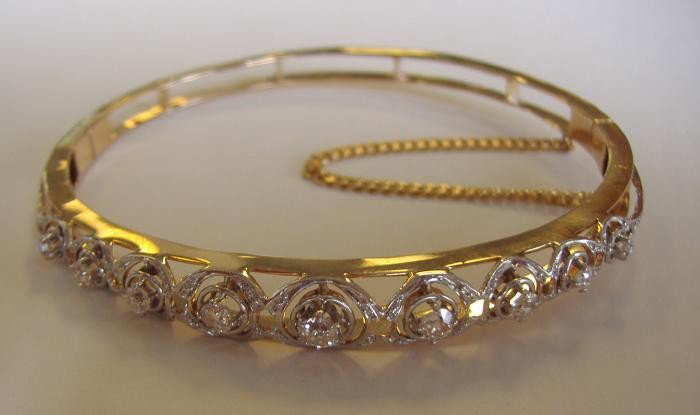 Art Deco Diamond Cuff Bracelet set in 14K Gold: Nine diamond cuff bracelet set in 14K white and yellow gold (tested). The overall weight, 11.2 grams. 7" inner circumference.