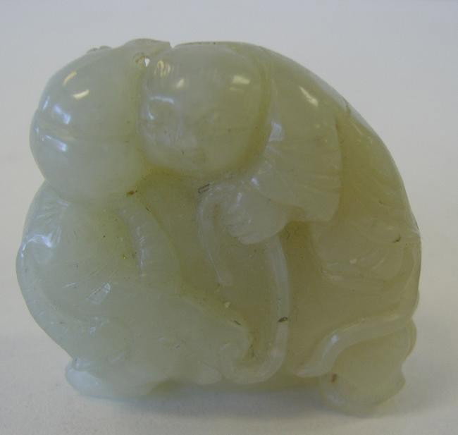 Chinese White Jade Carving of Buddha: The Chinese jade carving depicts Buddha ridding a water buffalo. The carving measures 1-5/8" high and 1-3/4" wide.