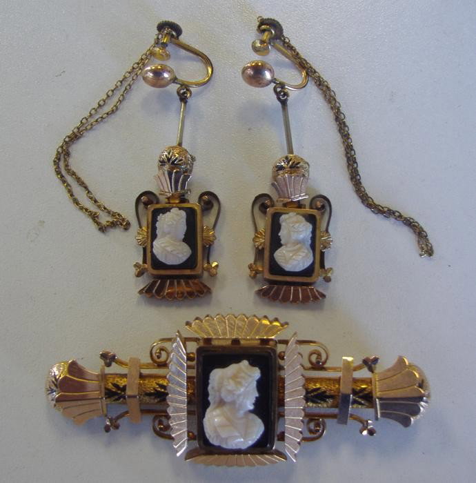 Victorian Gold & Enamel Brooch & Earring Set: c1880s brooch & earring set. Bar pin/brooch is gold with black enamel tracery and measures 2.5" long. The center with a black & white onyx cameo. Screw drop earrings to match. The gold does test 10K-1
