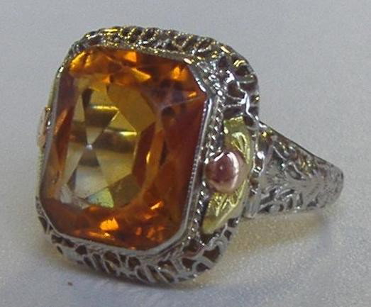 14K White Gold & Citrine Ring: Large citrine stone mounted in a 14K white gold filigree setting. Overall weight 3.8 grams. Ring size 6.25.