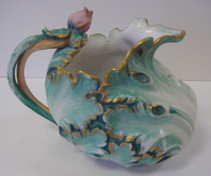 Pairpoint Limoges Ewer Pitcher: Porcelain pitcher measuring 9" long x 6.25" tall. The underside is signed Pairpoint Limoges and has an impressed 2028. See our photo showing an article from 1985 with a full description and a price of