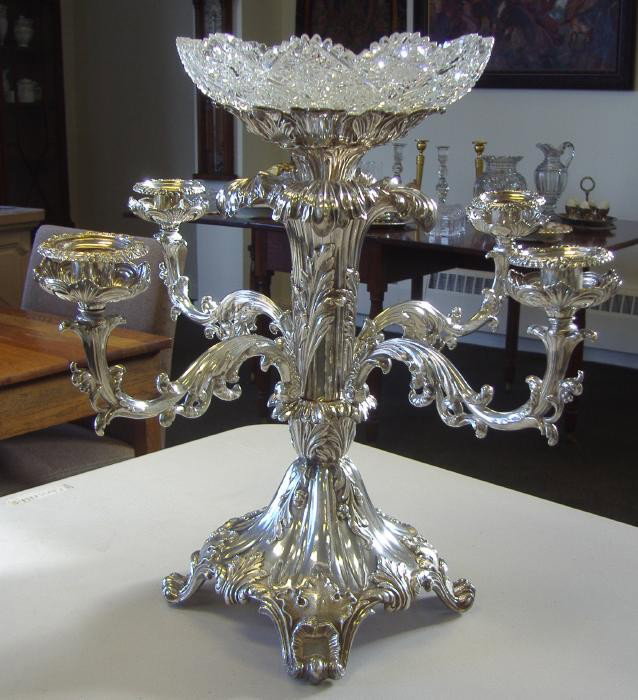 Silver & Crystal Epergne with 4 Arm Candelabra: Silver-plated epergne with four-arm candelabra, each numbered 1-4. The epergne has a cut crystal bowl at the top, (most likely not the original bowl). The epergne is marked on the underside with what 