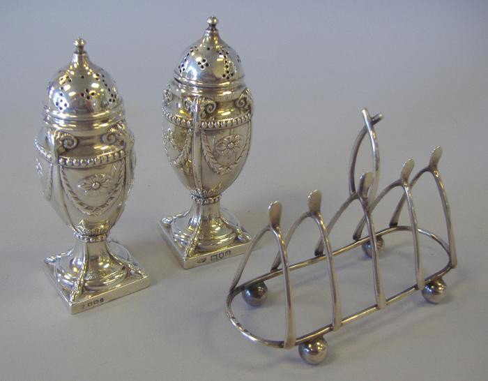 Sterling Toast Rack & Salt & Pepper Shakers: Sterling "wishbone" shaped toast rack, with hallmarks for Birmingham, 1900, Norton & White, together with sterling salt and pepper shakers. Hallmarks for Sheffield, England, 1896-97, Hawksworth,Eyre &