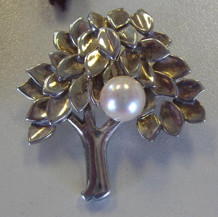 Tiffany & Co Sterling & Pearl "Tree" Brooch: Marked T & Co, 1999 and 925. Measures 1.5" high and 1" wide. Comes with Tiffany & Co brown pouch.