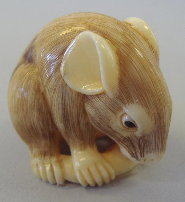 Japanese Carved Ivory Netsuke of a Rat, signed: Carved ivory and polychromed netsuke of a rat, signed. Measures 1.25" high.