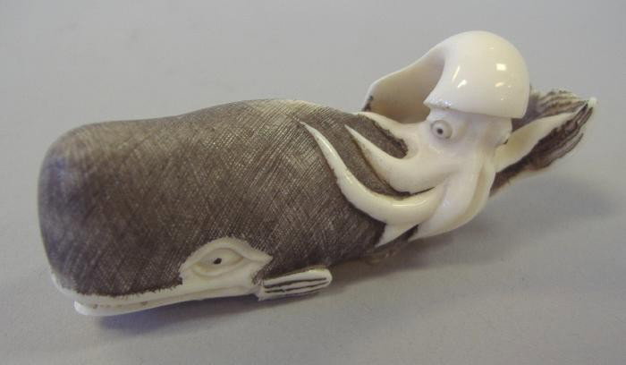 Japanese Ivory Netsuke of Whale & Octopus, signed: Carved ivory and polychromed netsuke of an octopus astride a whale, signed. Measures 2.5" long.