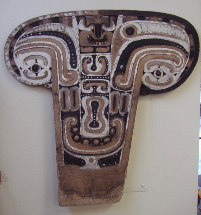 Vintage Polynesian Carved Wood Shield: Carved and painted shield measuring 31" tall and 32" wide.