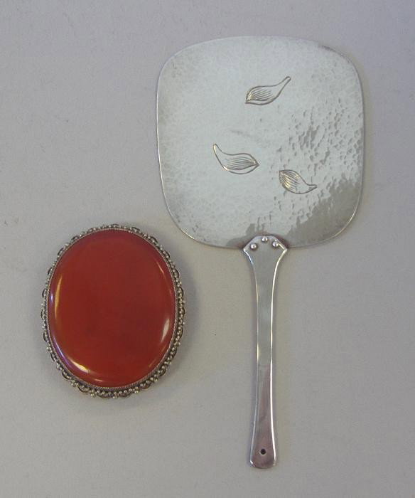 Chinese Silver Carnelian Brooch & Incense Fan: Large carnelian stone set in a silver filigree brooch. Marked China and Silver. Measures 2" x 1-5/8", together with a hand-hammered incense fan. One side etched with three leaves. Signed. Measures 5.5