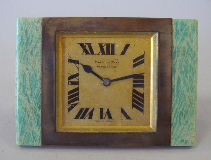 Mappin & Webb French Art Deco Clock: Mappin & Webb travel or desk clock. The Art Deco clock's face is flanked on each side with stone. Measures 2.5" x 3.75". Does not appear to be in working order. Marked Made in France