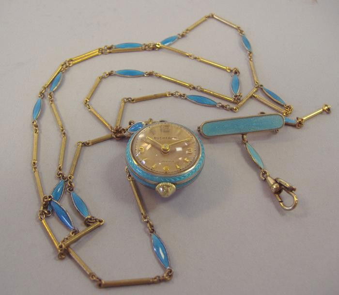 Bucherer Enamel Ball Clock & Necklace Chain: Bucherer enameled ball clock (17 jewels), with a long gilt-sterling and enamel neck chain. Also with a lapel watch clip and two additional links. Comes with original presentation box. Currently in wor