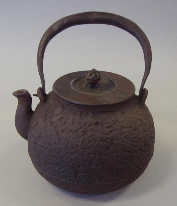Japanese Bronze Teapot, signed: Signed under the lid. Measures 8" to the top of the handle and 7" wide.